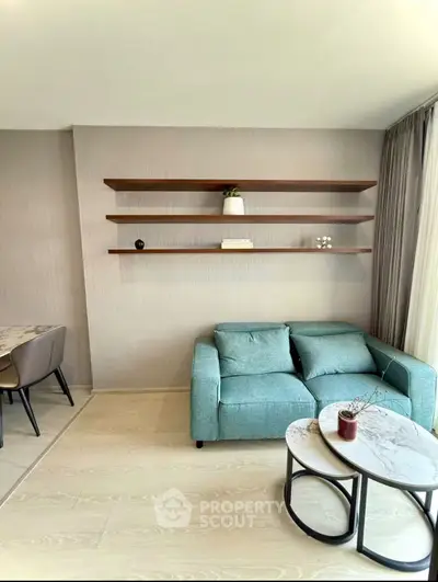 Modern living room with teal sofa and stylish wall shelves