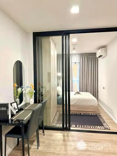 Modern compact bedroom with sliding glass doors and stylish decor