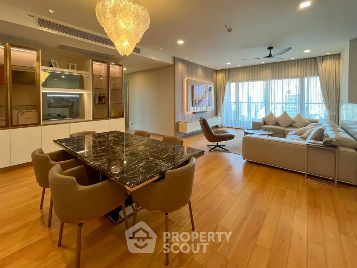 Spacious modern living room with elegant dining area and large windows for natural light.