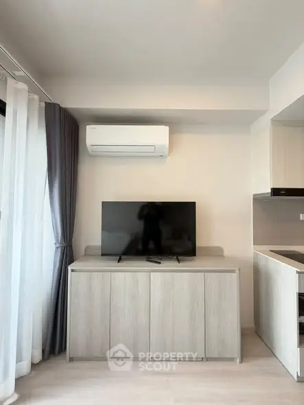 Modern living room with sleek TV setup and air conditioning