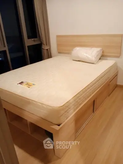 Cozy bedroom with wooden bed frame and large window view
