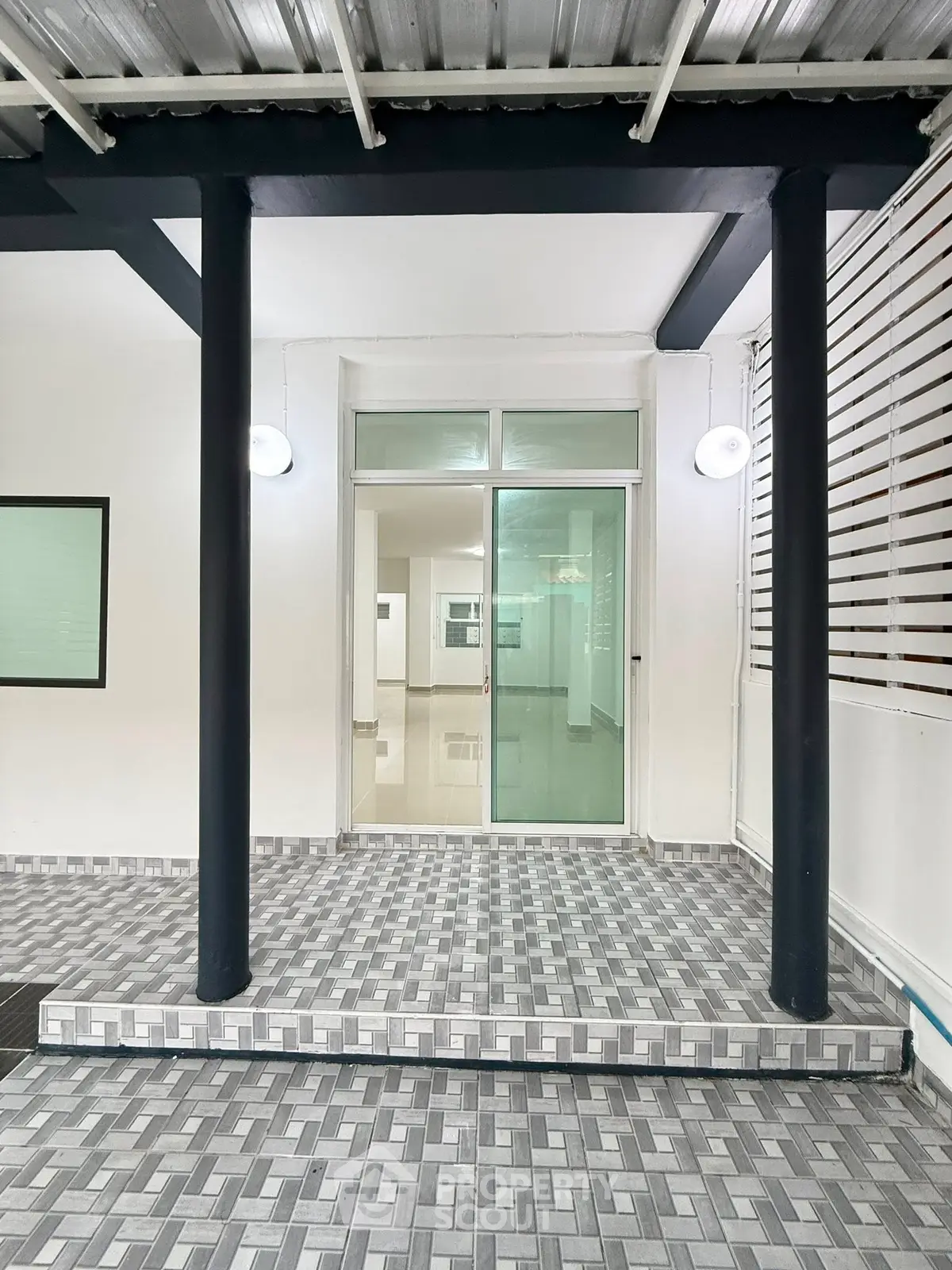Modern entrance with sleek tiled flooring and glass door