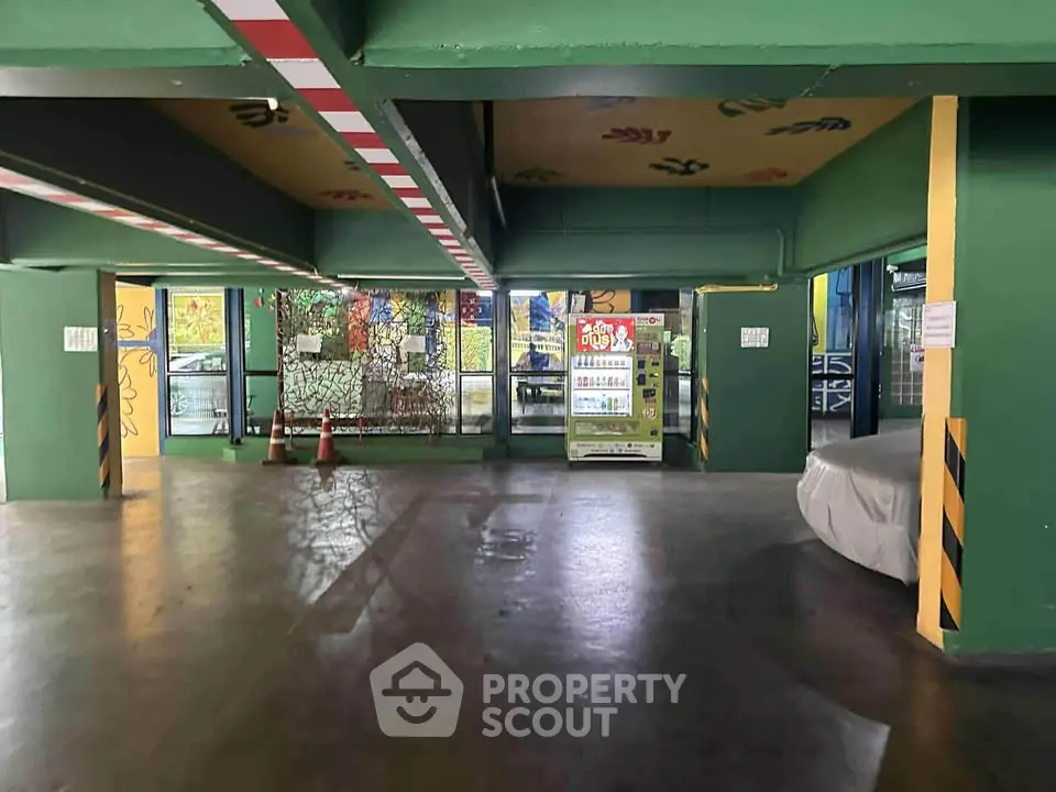 Spacious parking area with vibrant decor and vending machine