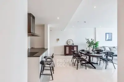 Spacious open-plan dining and living area with modern decor and sleek finishes.