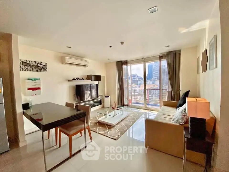 Modern living room with city view, sleek furniture, and natural light.