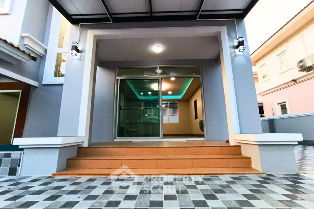 Modern home entrance with stylish lighting and tiled steps