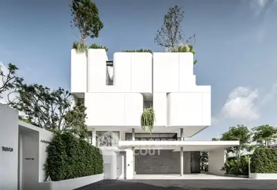 Stunning modern architectural home with lush greenery and sleek design.