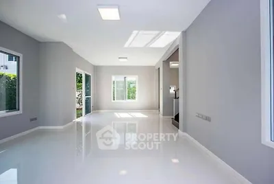 Spacious and bright living room with large windows and modern design.