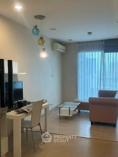 Modern living room with stylish lighting and cozy seating area.