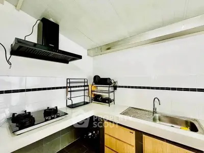 Modern kitchen with gas stove and sleek design in a stylish apartment.