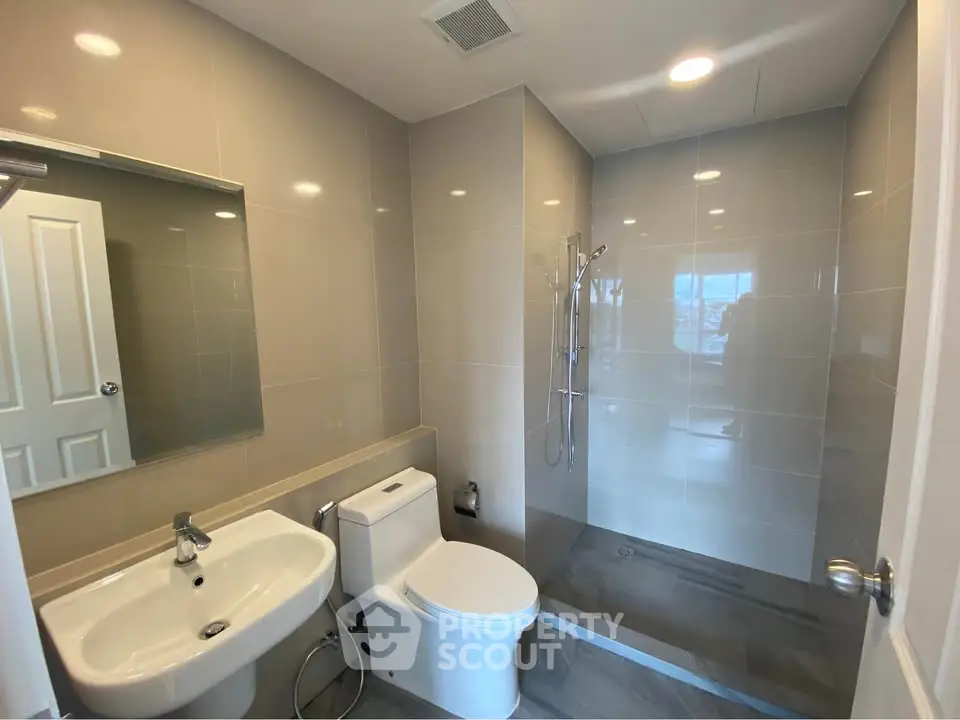 Modern bathroom with sleek fixtures and spacious shower area
