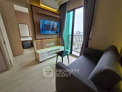 Modern living room with sleek furniture and city view balcony