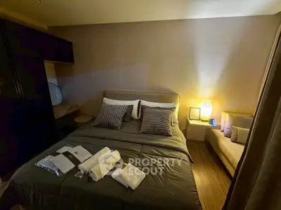Cozy bedroom with modern decor and ambient lighting, featuring a comfortable bed and stylish furnishings.