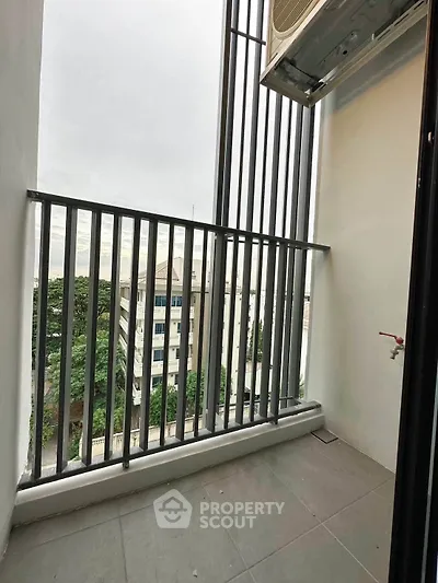 Modern balcony with sleek railing and city view, perfect for urban living.
