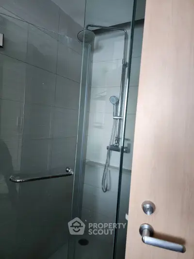 Modern bathroom with glass shower enclosure and sleek fixtures