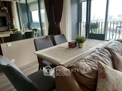 Modern living room with dining area and balcony view in urban apartment