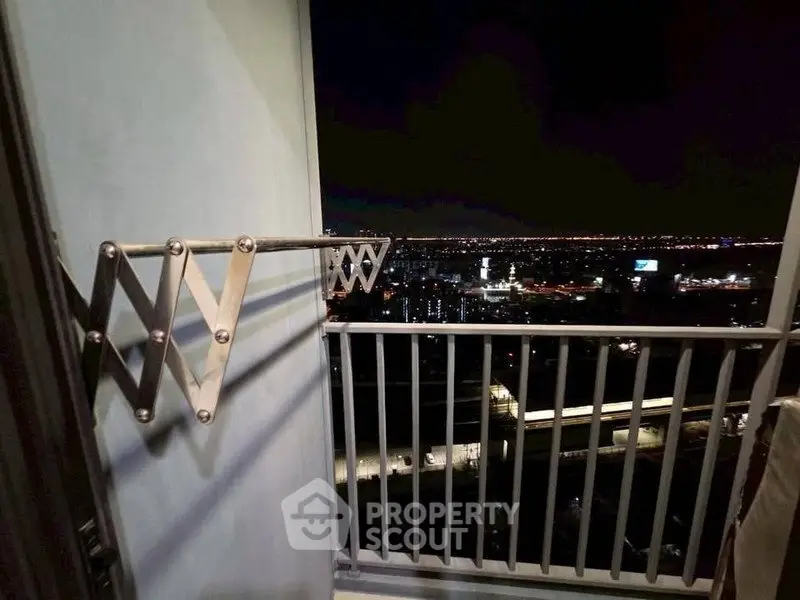 Stunning night cityscape view from a high-rise balcony with sleek railing design.