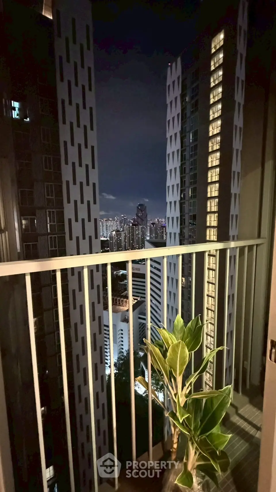 Stunning cityscape view from a modern high-rise balcony at night, perfect for urban living enthusiasts.