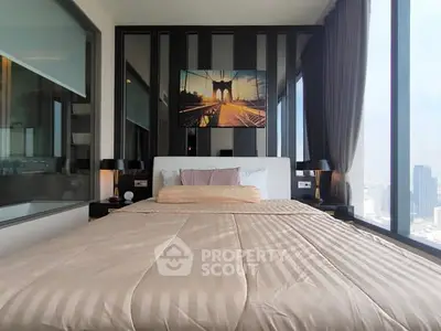 Luxurious bedroom with panoramic city views and modern decor in high-rise apartment.