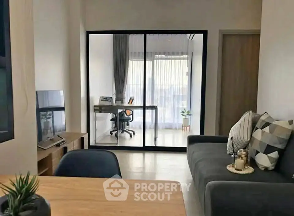 Modern living room with study area and stylish decor in a contemporary apartment.