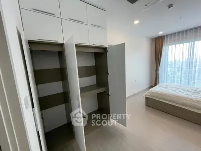 Modern bedroom with built-in wardrobe and large window view