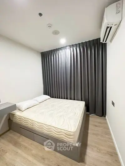 Modern bedroom with sleek design, featuring a comfortable bed and air conditioning for ultimate relaxation.