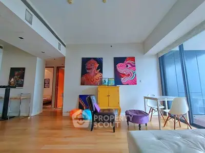 Modern living room with colorful art and floor-to-ceiling windows