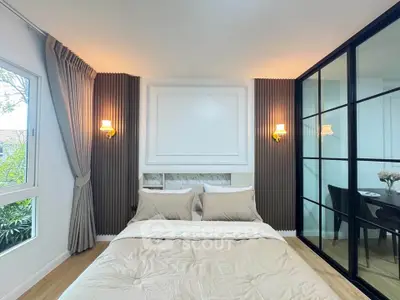 Elegant bedroom with modern decor and large window for natural light