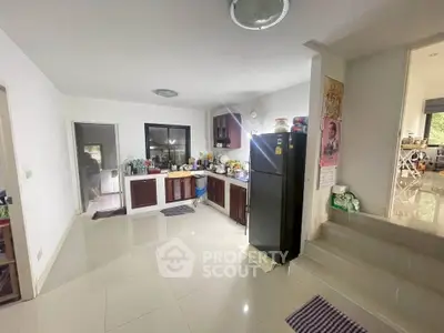Spacious kitchen with modern appliances and sleek design, perfect for culinary enthusiasts.
