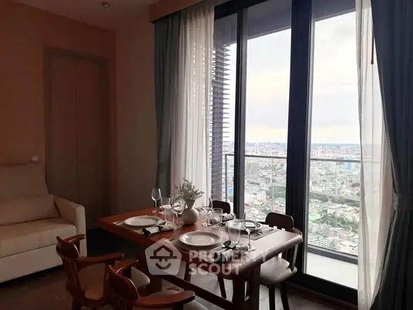 Elegant dining area with city view from high-rise apartment balcony