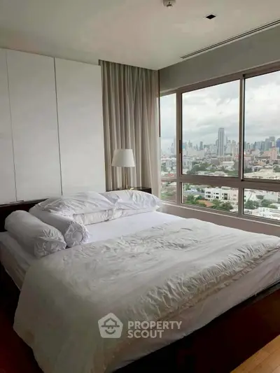 Luxurious bedroom with stunning city view and modern decor