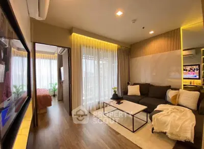Modern living room with cozy decor and natural light, featuring a stylish sofa and elegant curtains.