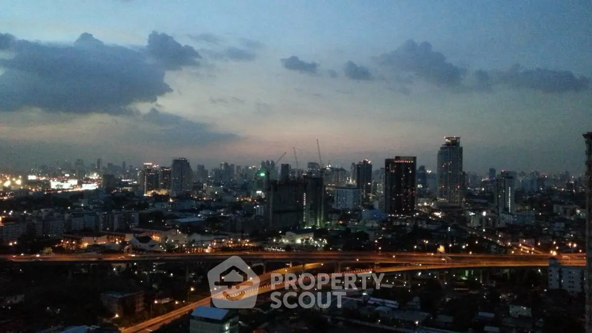 Stunning cityscape view at dusk with illuminated skyline and highways.
