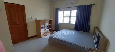 Spacious bedroom with natural light and modern furnishings