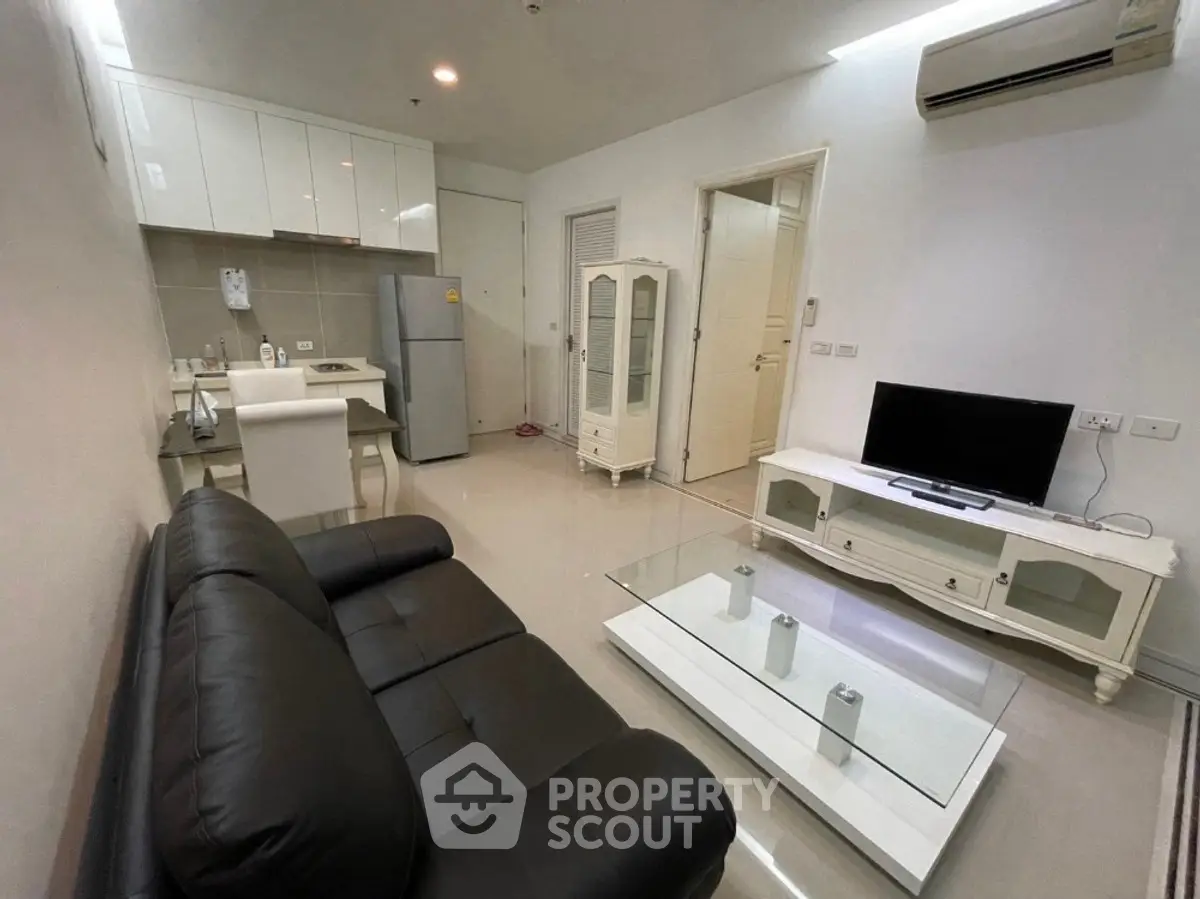 Modern living room with sleek furniture and open kitchen layout