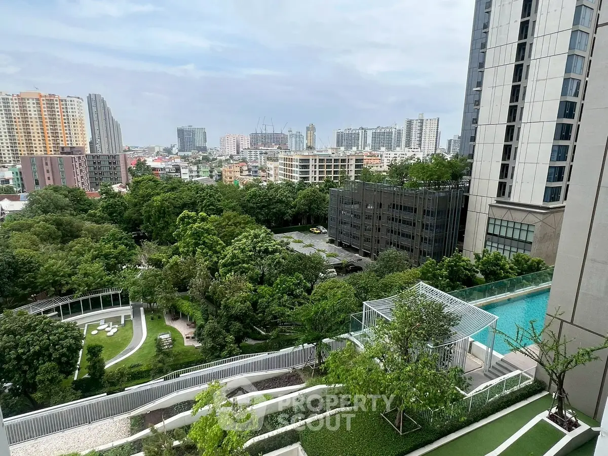 Stunning cityscape view from high-rise balcony with lush greenery and modern architecture.