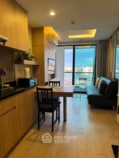 Modern open-layout kitchen and living room with city view balcony