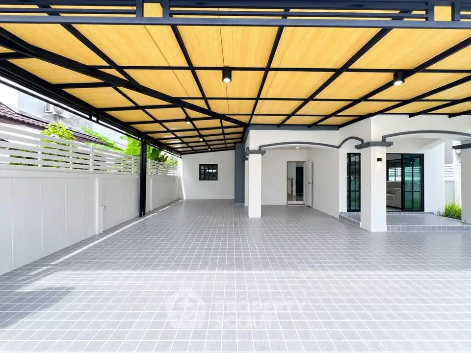 Spacious covered parking area with modern design and tiled flooring in a residential property.