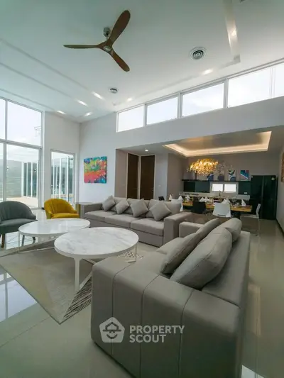 Luxurious modern living room with high ceilings and elegant decor