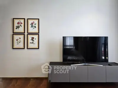 Modern living room with sleek TV stand and floral wall art, perfect for stylish home entertainment.