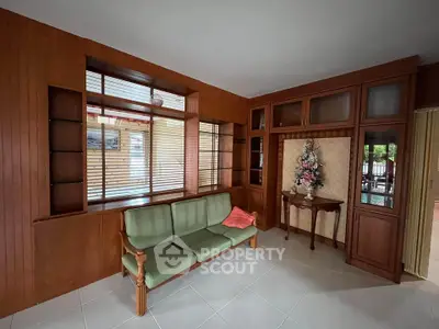 Charming living room with wooden paneling and vintage decor