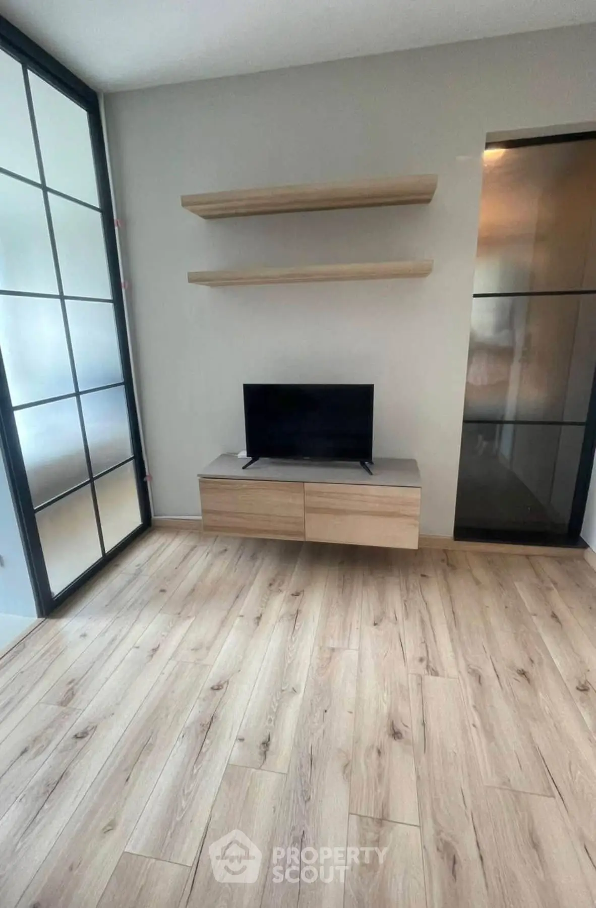 Modern living room with wooden flooring and sleek TV stand
