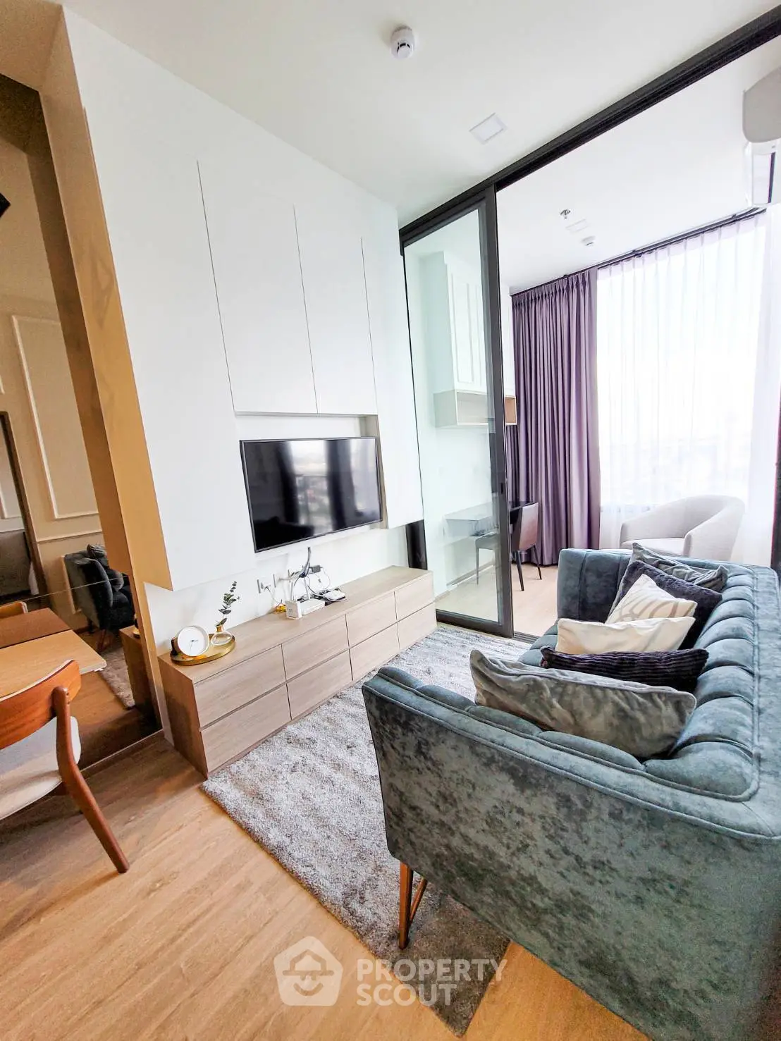 Modern living room with stylish furniture and large window offering natural light