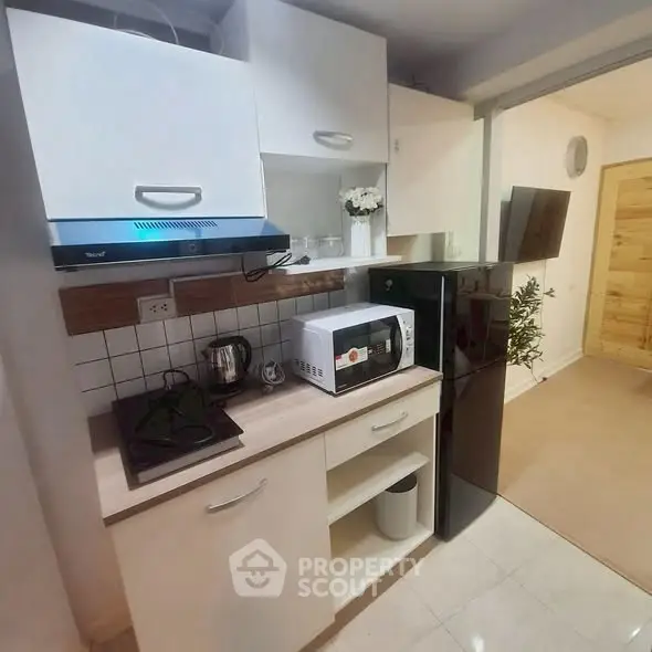 Compact kitchen with modern appliances and sleek cabinetry