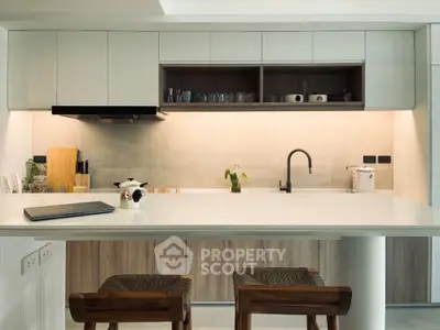 Modern kitchen with sleek cabinetry and stylish bar stools