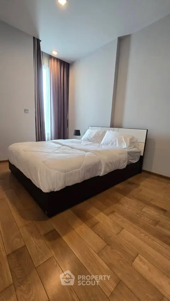 Spacious bedroom with modern design and natural light in a stylish apartment.
