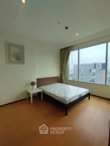 Spacious bedroom with city view and natural light