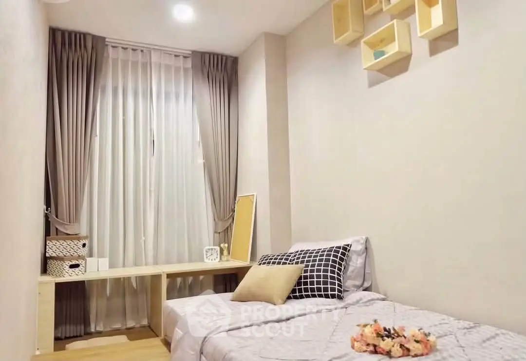 Cozy bedroom with modern decor and natural light, perfect for relaxation and comfort.