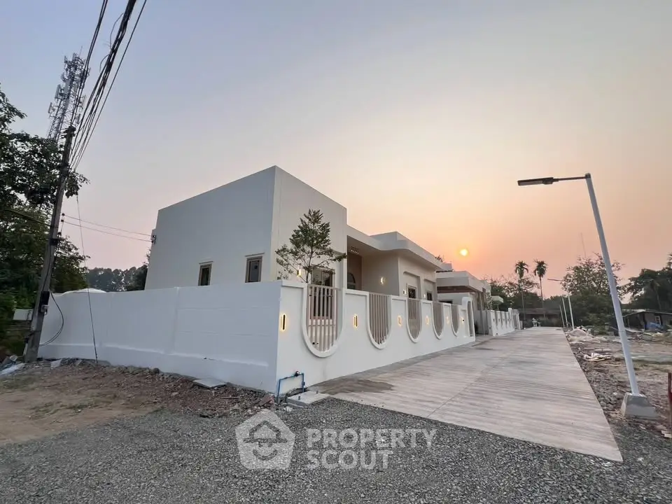 Modern minimalist home exterior with sleek design and sunset view