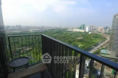 Stunning cityscape view from a high-rise balcony overlooking lush greenery and urban skyline.
